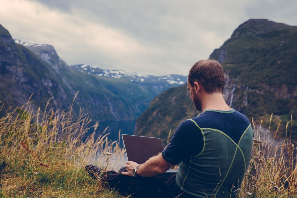 Man using laptop outdoors with reliable internet